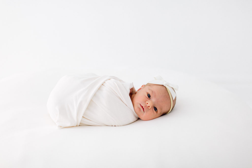 Photo of newborn baby swaddled in blanket by Cincinnati newborn photographer